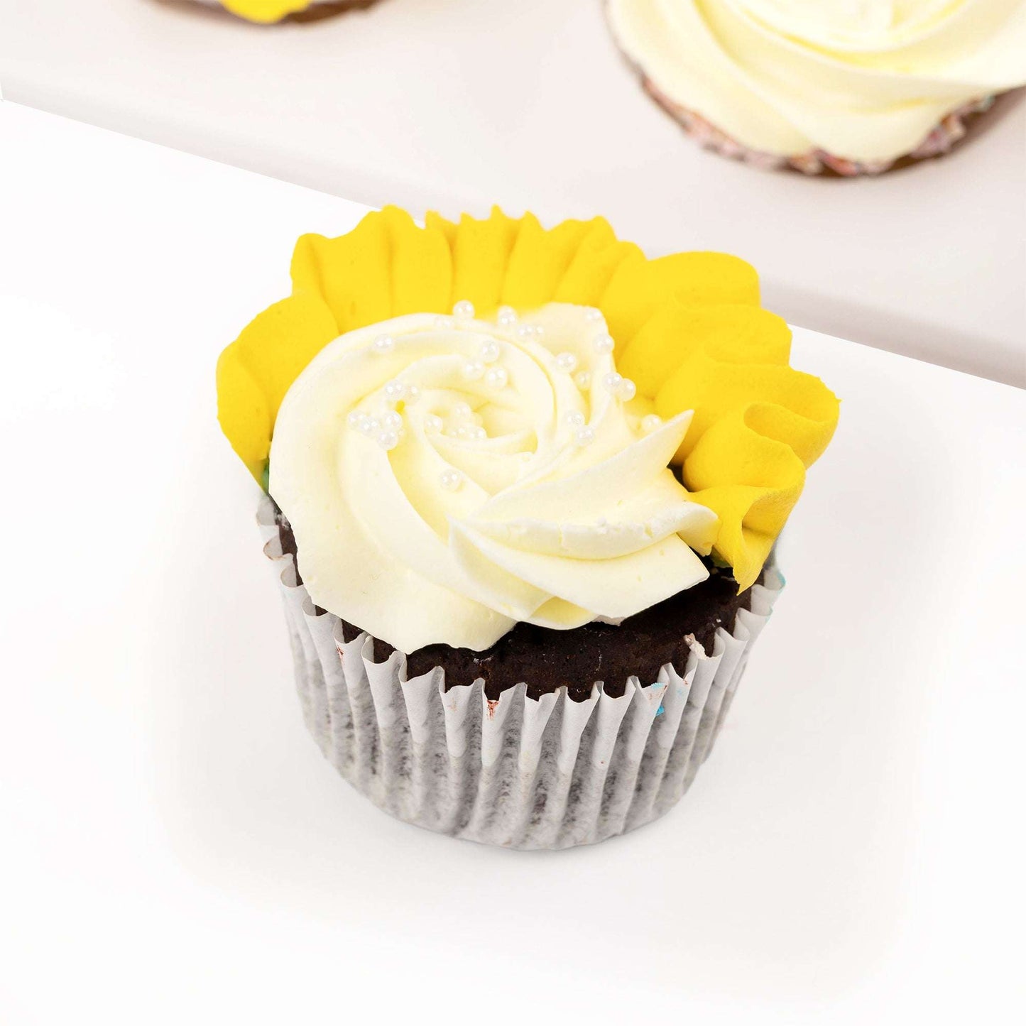 Close-up of a yellow and white buttercream cupcake from the get well gift