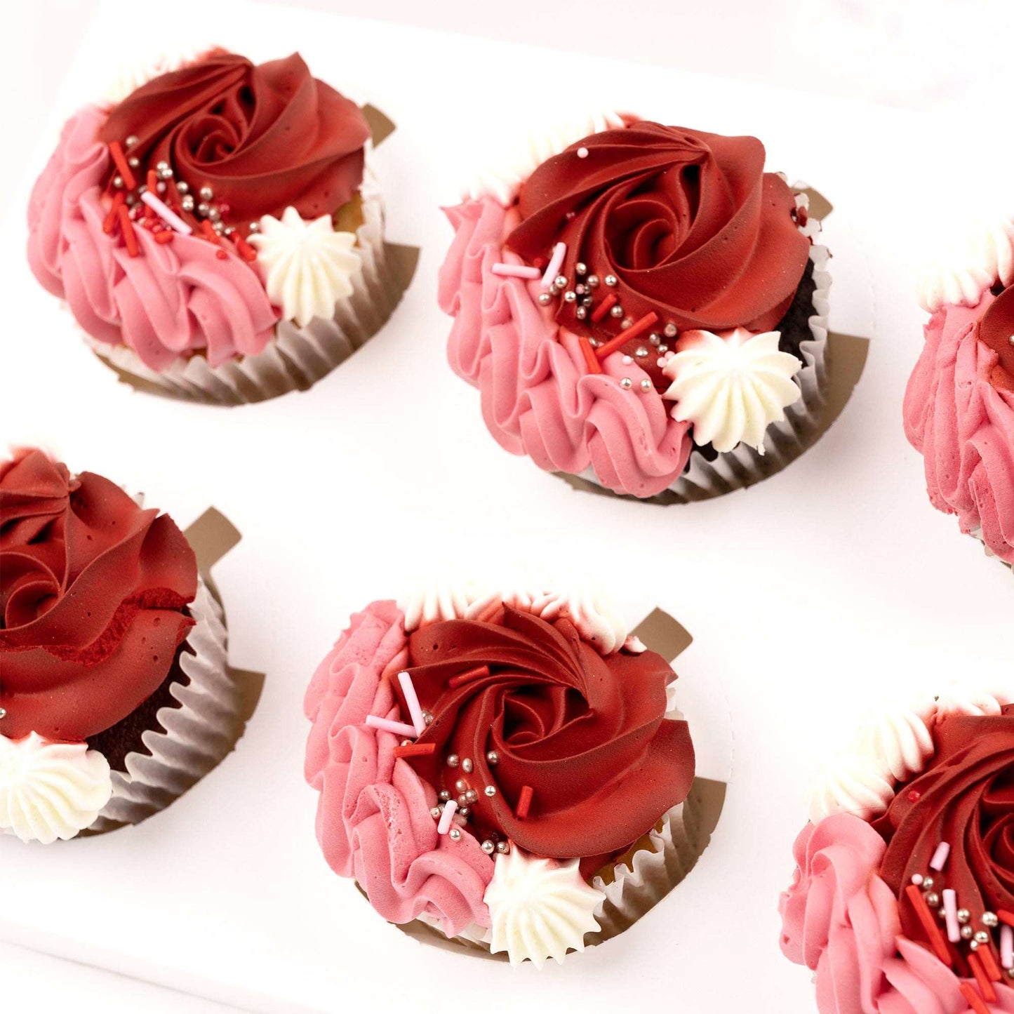 Close-up of red and pink buttercream cupcakes in the Love Bloom Cupcake Set