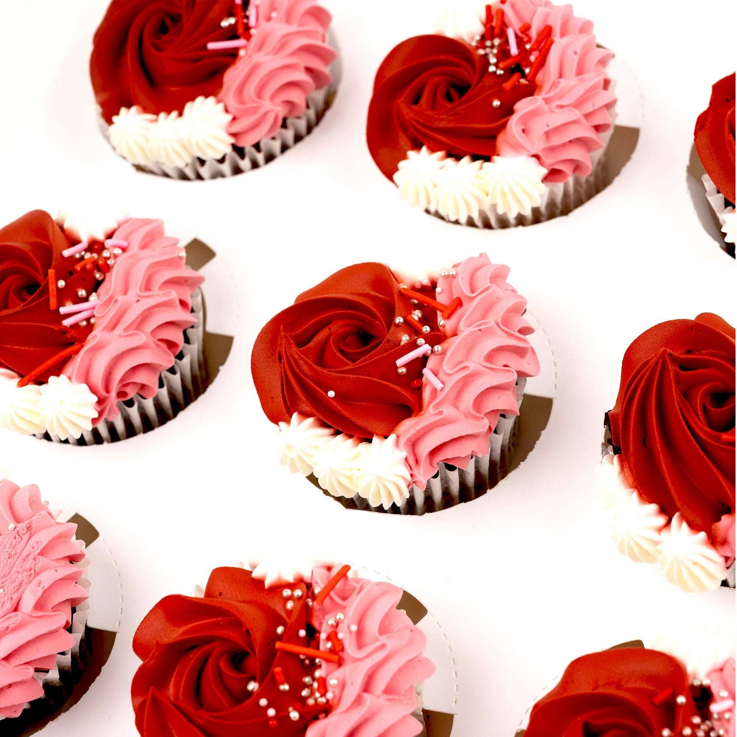 Close-up of red and pink buttercream cupcakes in the Rose Love Cupcake Bundle
