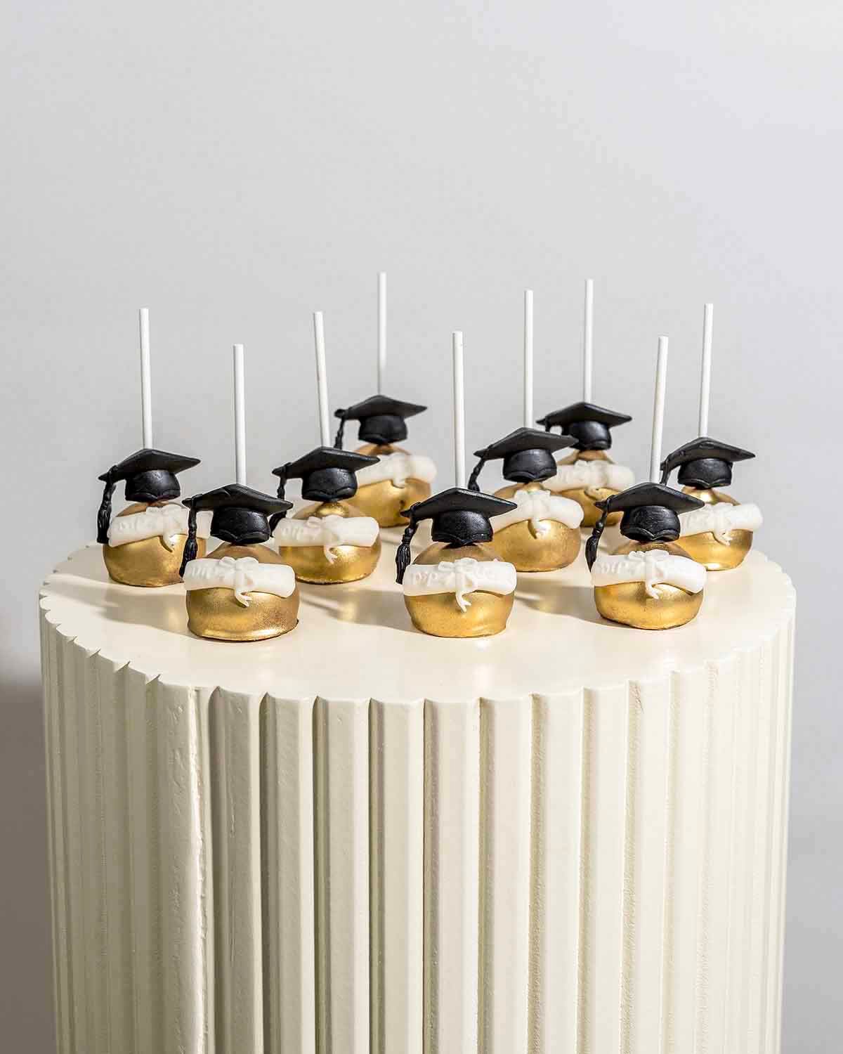 Graduation theme Chocolate Cake pops by NJD